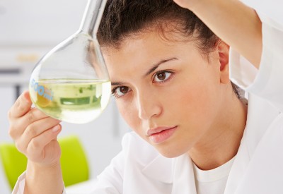 Female Scientist Studying Liquid In Flask